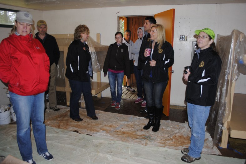 Group visits Fircrest Cabins under renovation by Karen and Candy at Camp Howard