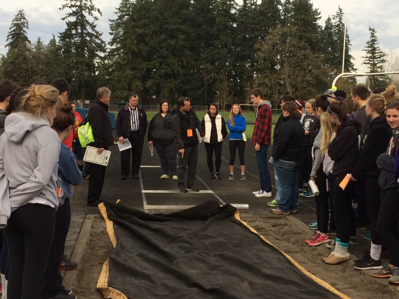 CYO Track and Field officials training assembled at the long jump pit