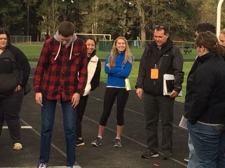 Paul Boileau (right) conducts training at the long jump pit