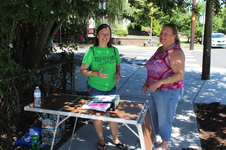 Nurse Cindy and Camp Registrar, Nora, chat at the bus stop