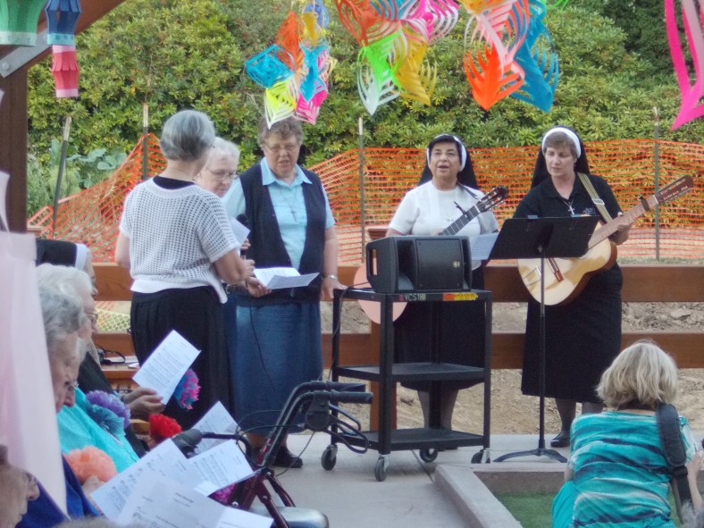 Sr. Josephine, Sr. Charlene, Sr. Juanita and Sr. Adele Marie lead prayer and song as the patio and bocce court are dedicated.