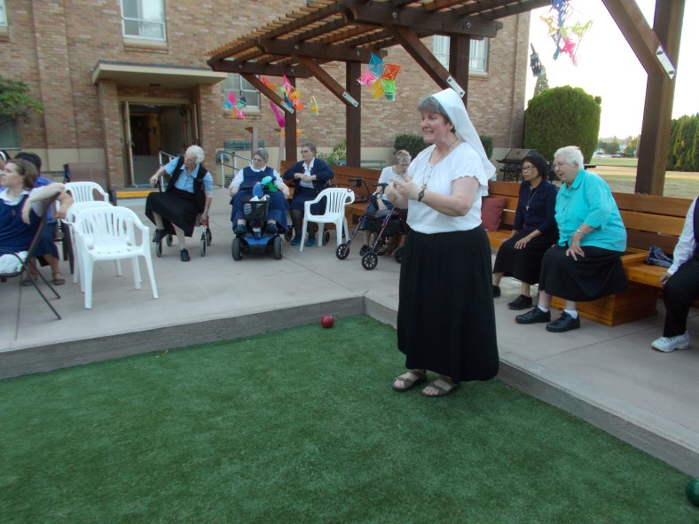 Sr. Colleen and partner take a turn as their names come up in the bracket.